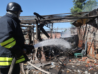 A rescuer is dealing with the aftermath of a Russian KAB aerial bomb attack in Kharkiv, northeastern Ukraine, on April 30, 2024. (