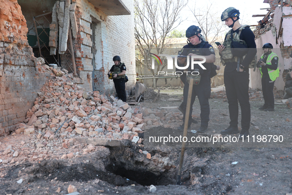 Law enforcers are documenting the destruction caused by the strike of Russian KAB guided bombs in Kharkiv, northeastern Ukraine, on April 30...