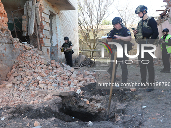 Law enforcers are documenting the destruction caused by the strike of Russian KAB guided bombs in Kharkiv, northeastern Ukraine, on April 30...