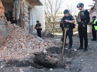 Law enforcers are documenting the destruction caused by the strike of Russian KAB guided bombs in Kharkiv, northeastern Ukraine, on April 30...