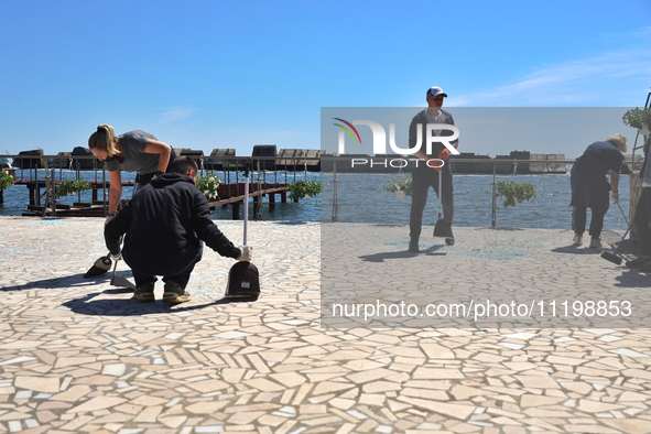 People are cleaning up the aftermath of a Russian missile attack on the waterfront in Odesa, Ukraine, on April 30, 2024. 