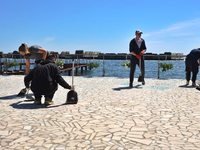 People are cleaning up the aftermath of a Russian missile attack on the waterfront in Odesa, Ukraine, on April 30, 2024. (