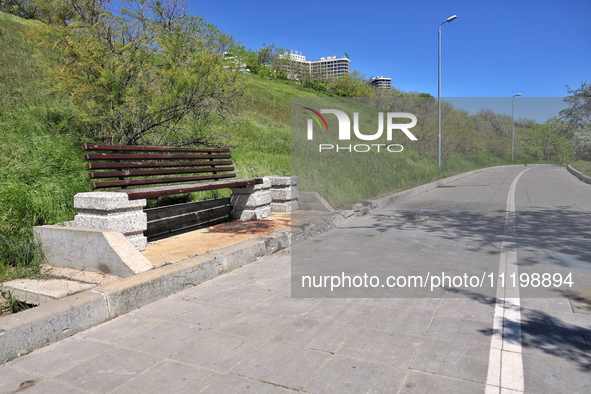 A spot of dried blood is visible on a bench in Odesa, Ukraine, on April 30, 2024, where a woman died due to a Russian missile strike on the...