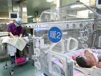 A nurse is caring for a child in the neonatal intensive care unit of the No 4 Hospital in Handan, Hebei Province, on May 1, 2024. (