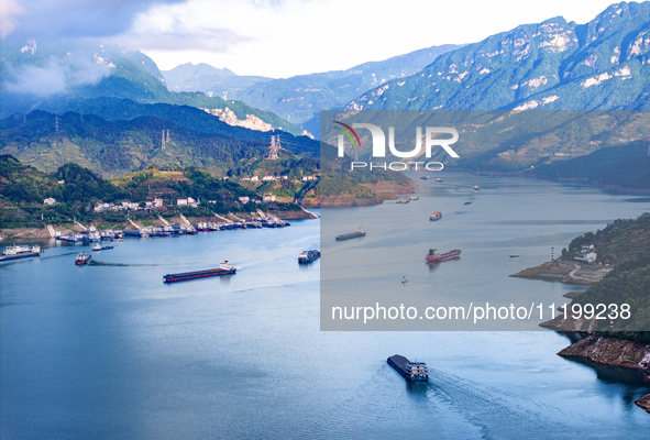 Transport ships are sailing in the waters in front of a dam in the Three Gorges reservoir area of the Yangtze River in Zigui County, Yichang...