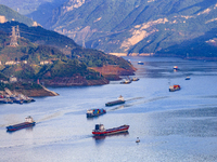 Transport ships are sailing in the waters in front of a dam in the Three Gorges reservoir area of the Yangtze River in Zigui County, Yichang...