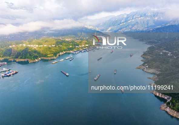 Transport ships are sailing in the waters in front of a dam in the Three Gorges reservoir area of the Yangtze River in Zigui County, Yichang...