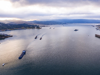 Transport ships are sailing in the waters in front of a dam in the Three Gorges reservoir area of the Yangtze River in Zigui County, Yichang...