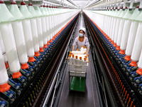 A worker is producing high-end yarn at a workshop in the Zaozhuang Economic Development Zone in Zaozhuang, China, on May 1, 2024. (