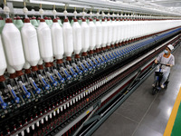 A worker is producing high-end yarn at a workshop in the Zaozhuang Economic Development Zone in Zaozhuang, China, on May 1, 2024. (