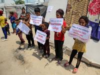 Palestinian youths are lifting placards to thank pro-Palestinian student solidarity initiatives in US and Canadian universities on their cam...