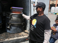 A World Central Kitchen (WCK) worker is preparing to serve meals to Palestinians at a school sheltering displaced people amid the ongoing co...