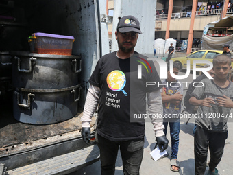 A World Central Kitchen (WCK) worker is preparing to serve meals to Palestinians at a school sheltering displaced people amid the ongoing co...