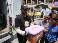 A World Central Kitchen (WCK) worker is preparing to serve meals to Palestinians at a school sheltering displaced people amid the ongoing co...