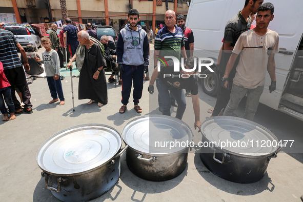 A World Central Kitchen (WCK) worker is preparing to serve meals to Palestinians at a school sheltering displaced people amid the ongoing co...