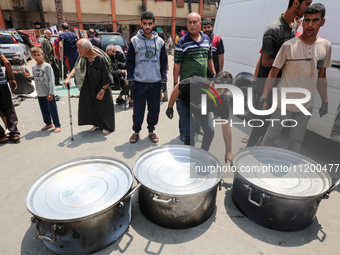 A World Central Kitchen (WCK) worker is preparing to serve meals to Palestinians at a school sheltering displaced people amid the ongoing co...