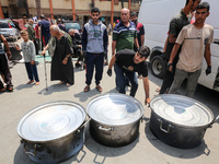 A World Central Kitchen (WCK) worker is preparing to serve meals to Palestinians at a school sheltering displaced people amid the ongoing co...