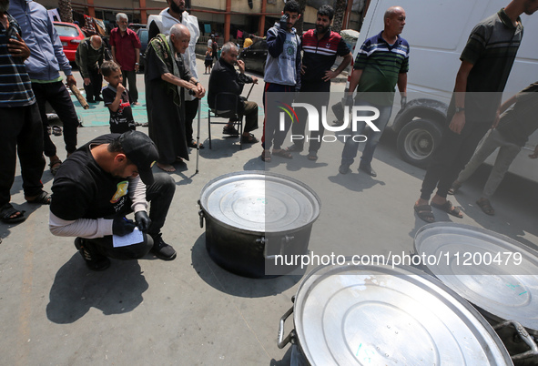 A World Central Kitchen (WCK) worker is preparing to serve meals to Palestinians at a school sheltering displaced people amid the ongoing co...