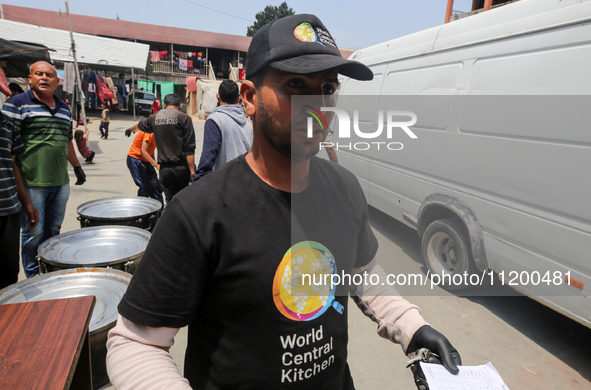 A World Central Kitchen (WCK) worker is preparing to serve meals to Palestinians at a school sheltering displaced people amid the ongoing co...