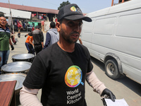 A World Central Kitchen (WCK) worker is preparing to serve meals to Palestinians at a school sheltering displaced people amid the ongoing co...