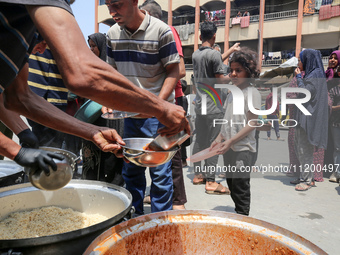 Palestinians are gathering to receive food meals cooked by World Central Kitchen (WCK) after the charity resumed operations at a school shel...