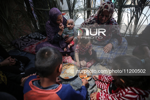 Palestinians are gathering to receive food meals cooked by World Central Kitchen (WCK) after the charity resumed operations at a school shel...