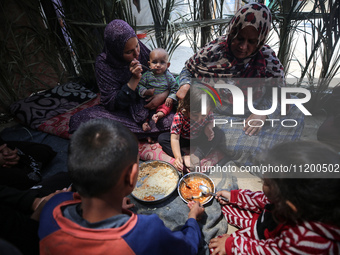 Palestinians are gathering to receive food meals cooked by World Central Kitchen (WCK) after the charity resumed operations at a school shel...