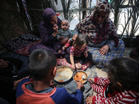 Palestinians are gathering to receive food meals cooked by World Central Kitchen (WCK) after the charity resumed operations at a school shel...