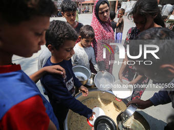 Palestinians are gathering to receive food meals cooked by World Central Kitchen (WCK) after the charity resumed operations at a school shel...