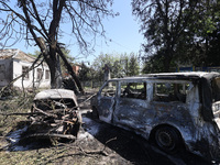 Burnt-out cars are being seen in the street following a Russian strike on Zolochiv in the Kharkiv region, northeastern Ukraine, with guided...