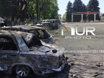 Burnt-out cars are being seen in the street following a Russian strike on Zolochiv in the Kharkiv region, northeastern Ukraine, with guided...