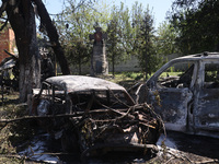 Burnt-out cars are being seen in the street following a Russian strike on Zolochiv in the Kharkiv region, northeastern Ukraine, with guided...