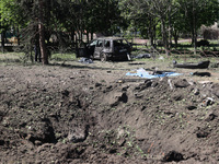 A crater is being seen in the ground following a Russian strike on Zolochiv in the Kharkiv region, northeastern Ukraine, on May 1, 2024, wit...