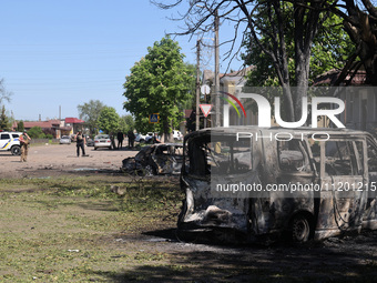 Burnt-out cars are being seen in the street following a Russian strike on Zolochiv in the Kharkiv region, northeastern Ukraine, with guided...