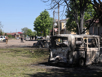 Burnt-out cars are being seen in the street following a Russian strike on Zolochiv in the Kharkiv region, northeastern Ukraine, with guided...