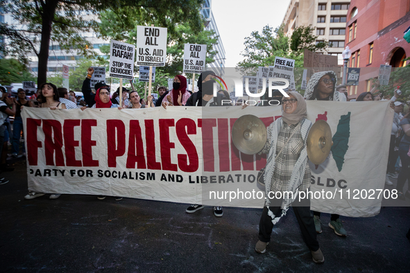 Workers and supporters of a ceasefire in Gaza demonstrate on International Workers’ Day, Washington, DC, May 1, 2024.  Speakers from a varie...