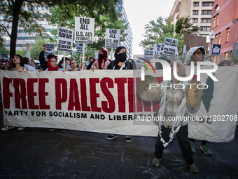 Workers and supporters of a ceasefire in Gaza demonstrate on International Workers’ Day, Washington, DC, May 1, 2024.  Speakers from a varie...