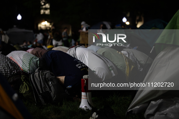 Students pray at the George Washington University Gaza encampment, Washington, DC, May 1, 2024.  GWU students established the camp the prior...