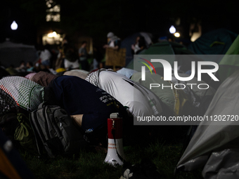 Students pray at the George Washington University Gaza encampment, Washington, DC, May 1, 2024.  GWU students established the camp the prior...