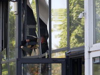 A man is clearing away glass shards at a Nova Poshta depot that was damaged by a Russian ballistic missile strike in Odesa, Ukraine, on May...