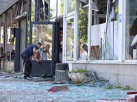 A man is clearing away glass shards at a Nova Poshta depot that was damaged by a Russian ballistic missile strike in Odesa, Ukraine, on May...