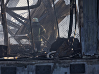 A firefighter is putting out a fire at a Nova Poshta depot and cargo branch in Odesa, Ukraine, on May 2, 2024, which was damaged by a Russia...