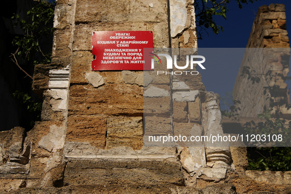 A warning sign is being displayed on the ruins of the 19th-century Dubiecki Manor in Vasylivka, Ukraine, on April 30, 2024. The house, known...