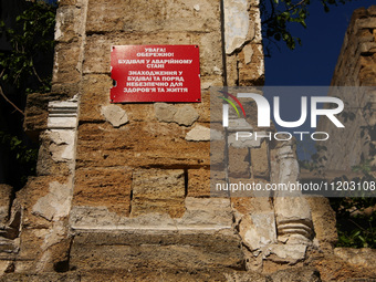 A warning sign is being displayed on the ruins of the 19th-century Dubiecki Manor in Vasylivka, Ukraine, on April 30, 2024. The house, known...