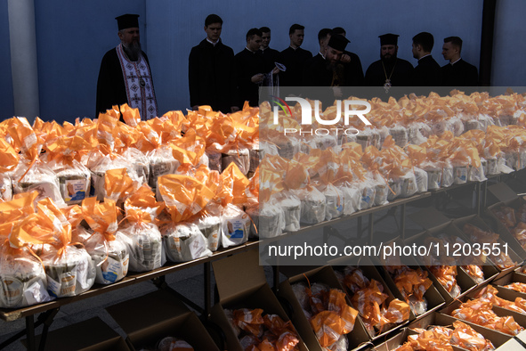 Metropolitan Epiphanius I, the head of the Orthodox Church of Ukraine, is leading a service to bless Easter cakes that are being sent to Ukr...