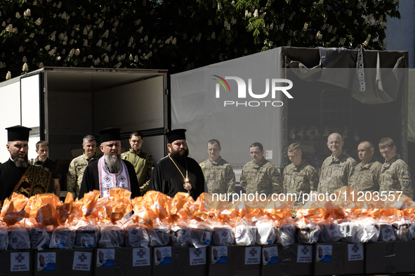 Metropolitan Epiphanius I, the head of the Orthodox Church of Ukraine, is leading a service to bless Easter cakes that are being sent to Ukr...