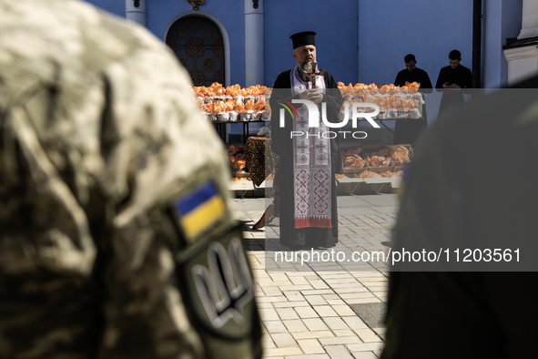 Metropolitan Epiphanius I, the head of the Orthodox Church of Ukraine, is leading a service to bless Easter cakes that are being sent to Ukr...