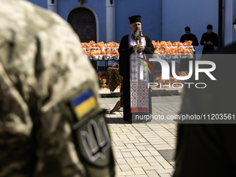 Metropolitan Epiphanius I, the head of the Orthodox Church of Ukraine, is leading a service to bless Easter cakes that are being sent to Ukr...