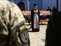 Metropolitan Epiphanius I, the head of the Orthodox Church of Ukraine, is leading a service to bless Easter cakes that are being sent to Ukr...