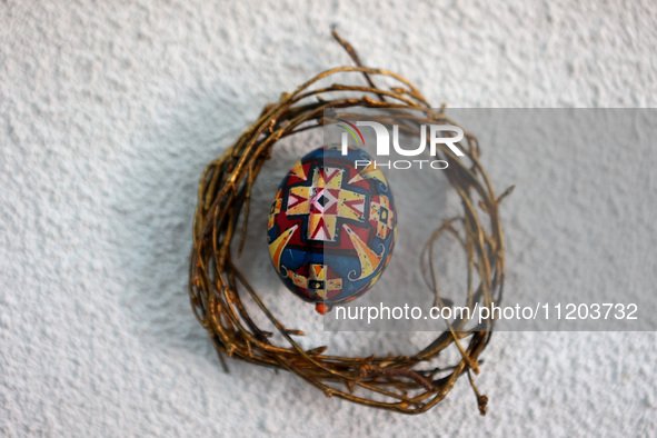 A Ukrainian Easter egg, known as the pysanka, is being surrounded by a wreath made of twigs in Rynok Square ahead of Orthodox Easter on May...